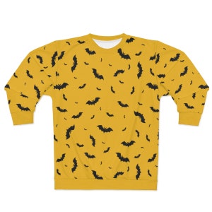 May include: A yellow sweatshirt with a black bat pattern.