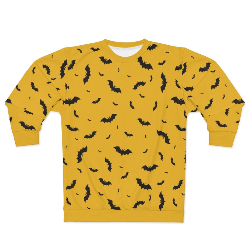 May include: A yellow sweatshirt with a black bat pattern.