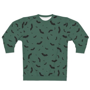 May include: A green sweatshirt with a black bat pattern. The bats are scattered randomly across the sweatshirt.