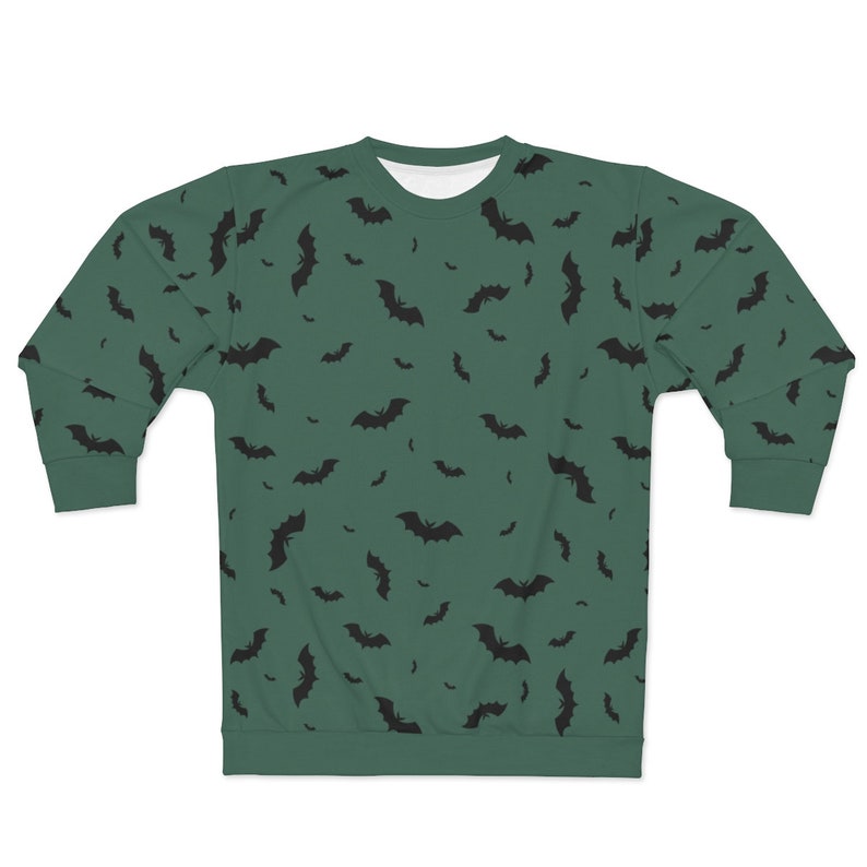 May include: A green sweatshirt with a black bat pattern. The bats are scattered randomly across the sweatshirt.