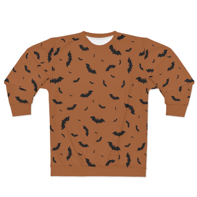May include: A brown sweatshirt with a black bat pattern. The bats are scattered randomly across the sweatshirt.