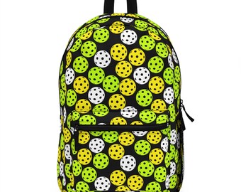 May include: Black backpack with a repeating pattern of yellow and green pickleball balls on a black background.
