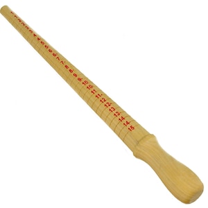 May include: A wooden ring sizer with red numbers from 1 to 16. The sizer is a long, thin piece of wood with a handle at one end.