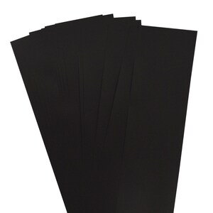 May include: A stack of 10 black sheets of paper.