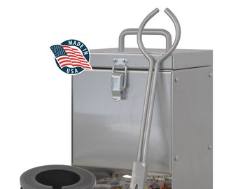 May include: A stainless steel kiln with a handle, latch, and digital display. A pair of metal tongs with blue handles and a dark gray crucible are in front of the kiln. A "Made in USA" sticker is on the kiln.