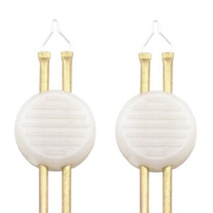 May include: Two white ceramic candle holders with gold metal stems. Each holder has a circular base with a textured surface.