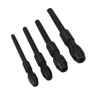 May include: Set of four black drill chucks with different sizes. The chucks have a knurled grip and a threaded end.