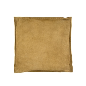 May include: A brown suede pillow with a stitched edge.