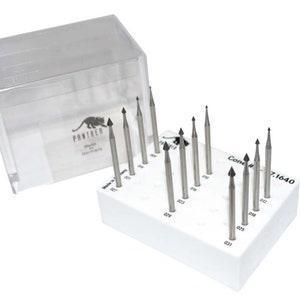 May include: A collection of silver drill bits with black tips, displayed in a white holder. The holder is marked with numbers and the text "Cone # 7.1640". A clear plastic case, bearing the "Panther Made in Germany" logo, is open beside the holder.