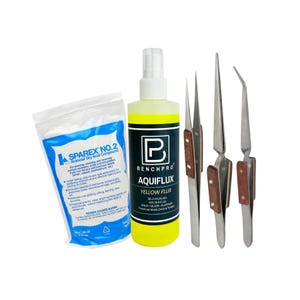 May include: A collection of soldering tools and supplies, including a bottle of yellow flux, a bag of granular dry acid compound, and three pairs of tweezers with wooden handles. The items are arranged on a white background.