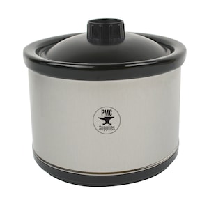 May include: A silver slow cooker with a black lid and a black base. The slow cooker has a logo that says "PMC Supplies" with a black anvil graphic.