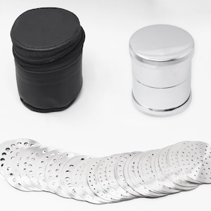May include: A set of 25 silver metal grinders with a black leather carrying case. The grinders are round and have a perforated design.
