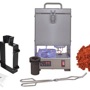 May include: A silver metal melting furnace with a digital temperature display reading 94.1 degrees. The furnace is surrounded by various tools for metal casting, including a crucible, tongs, two black molds, and a bag of casting flux. A pile of red casting sand is also included.