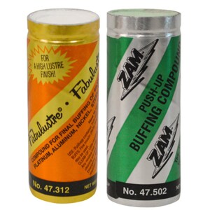 May include: Two metal cans of polishing compound. The yellow can is labeled "Fabulustre" and has the text "Compound for final buffing of platinum, aluminum, nickel, steel" and "No. 47.312". The green can is labeled "ZAM" and has the text "Push-Up Buffing Compound" and "No. 47.502".