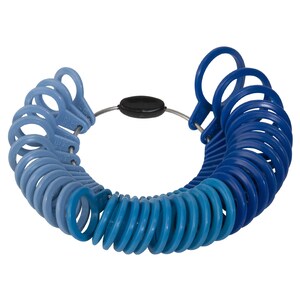 May include: A blue plastic ring sizer with a metal band and a black plastic connector. The sizer has a range of sizes from 4 to 13.