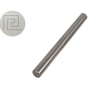 May include: A silver metal rod with a rounded end. The rod has a small, engraved design of a square with a curved line inside.
