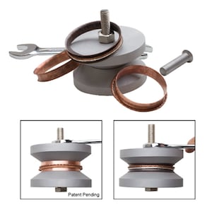 May include: A metal ring mandrel with a wrench and a copper ring. The mandrel has a screw and a base. The text "Patent Pending" is visible on the base.
