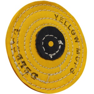 May include: A yellow buffing wheel with a black center and white stitching. The wheel is labeled "YELLOW  7/8 INCH".