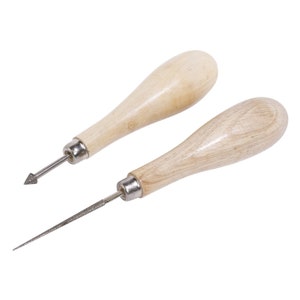 May include: Two wooden-handled awls with metal tips. The awls are used for piercing holes in leather or other materials.