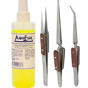 May include: A clear bottle of yellow liquid labeled "Aquiflux Jeweler's Self-Pickling Liquid Hard Soldering Flux for all types of jewelers' metals". The bottle is next to three silver tweezers with brown wooden handles.