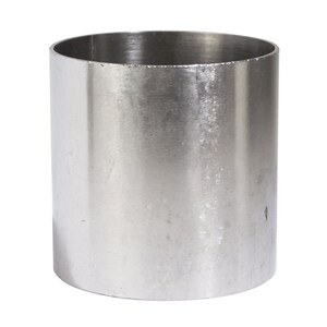 May include: A silver metal cylinder with a smooth, slightly textured surface. The cylinder is empty and has a rounded top and bottom.
