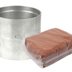 May include: A set of two metal rings and a block of brown clay, packaged in plastic wrap. The rings are silver and have a textured surface. The clay is a rich brown color.