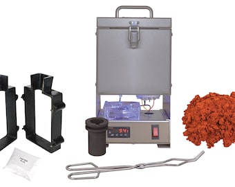 May include: A silver metal melting furnace with a digital temperature display reading 94.1 degrees. The furnace is surrounded by various tools for metal casting, including a crucible, tongs, two black molds, and a bag of casting flux. A pile of red casting investment material is also included.