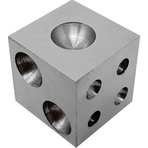 May include: A silver-colored metal cube with various sized holes and a hemispherical indentation on one side. The cube is likely a jeweler's tool or a component for another device. The cube is shown against a white background.