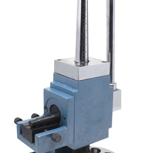 May include: A blue metal ring sizer with a silver handle and a graduated rod. The sizer has a circular base with multiple ring sizing holes.