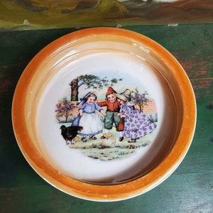 Vintage child&#39;s feeding dish, orange lusterware transfer, three children watching chickens decorate this bowl made in Bavaria