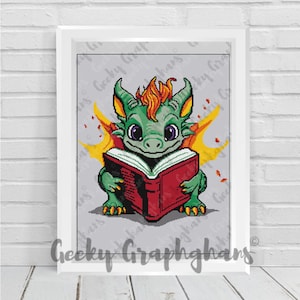 May include: A green dragon with orange flames for wings is reading a red book. The dragon is sitting on a gray background.