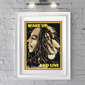 May include: A black and white cross-stitch pattern featuring Bob Marley with the text "Wake Up and Live" and the artist's name "The Woolly Duck".