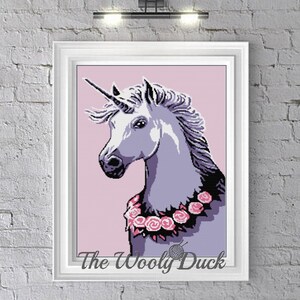 May include: A white unicorn with a pink and purple mane and tail, wearing a pink rose garland. The background is a light pink color. The image is titled "The Woolly Duck".