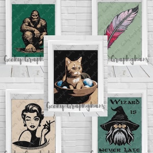 May include: Five framed art prints with different designs. One shows a Bigfoot, another a feather, a third a cat in a bowl, a fourth a woman smoking, and the last a wizard with the text "Wizard is Never Late."