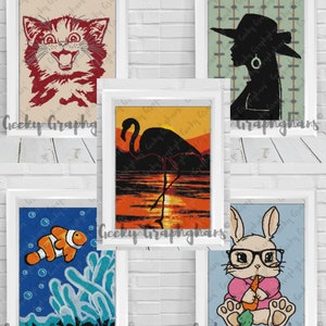 May include: Five framed illustrations with white frames. The illustrations are of a red cat with wide eyes, a black silhouette of a woman wearing a hat, a flamingo standing in a sunset, a clownfish swimming in blue water, and a bunny wearing glasses and holding a carrot.