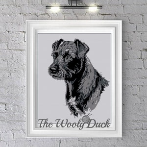 Puede incluir: Patrón de crochet en blanco y negro de la cabeza de un perro. El perro tiene un pelaje corto y áspero y mira hacia la izquierda. El patrón se titula "The Wooly Duck".