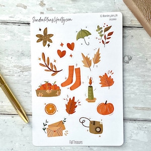 May include: A sheet of fall-themed stickers with illustrations of leaves, pumpkins, oranges, a candle, socks, a camera, an umbrella, a basket of oranges, and a flower. The text "Fall Treasures" is at the bottom of the sheet.