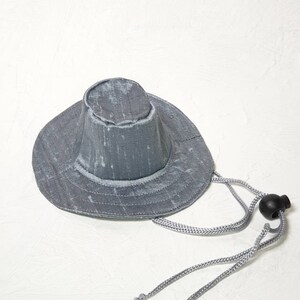 Puede incluir: Un sombrero de sol gris de ala ancha con una corona cinchada y un cord&oacute;n de ajuste gris.