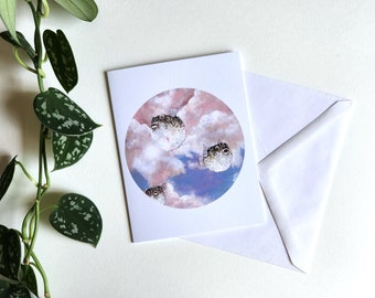 Greeting card of pufferfish in the sky