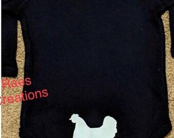 May include: Black long-sleeved onesie with a white silhouette of a chicken on the bottom.