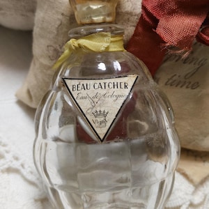 May include: A set of three ceramic canisters with lids, featuring a blue and white floral pattern. The canisters vary in size, with the largest measuring approximately 8 inches in height. They are arranged on a white surface.