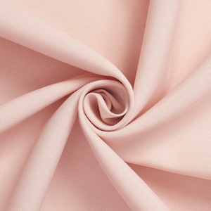 May include: A close-up of a soft, pink fabric with a smooth texture. The fabric is folded and draped, creating a gentle, flowing effect.