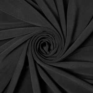 May include: Close-up of black fabric with a swirling, spiral pattern. The fabric is smooth and has a subtle sheen.