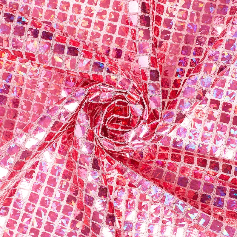 May include: Pink iridescent fabric with a square pattern. The fabric is gathered in the center, creating a swirling effect.