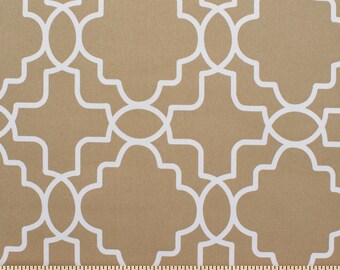 May include: Beige fabric with a white geometric pattern. The pattern is a repeating design of interlocking circles and squares.