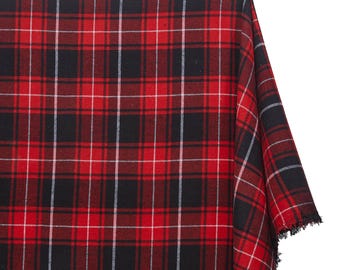 May include: A folded piece of red, black, and white plaid fabric. The fabric has a classic tartan pattern with intersecting lines creating a grid. The edges of the fabric are frayed.