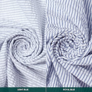 May include: Two fabric samples with blue and white stripes. One is light blue, the other is royal blue. The fabric is gathered and swirled, showing the texture and pattern. The text at the bottom reads "LIGHT BLUE" and "ROYAL BLUE".