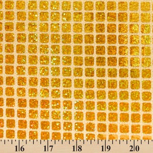 May include: Gold glitter fabric with a square grid pattern. The fabric is measured in inches.