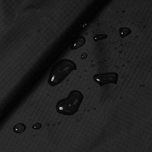 May include: Close-up of a black fabric with water droplets on the surface. The fabric appears to be waterproof.