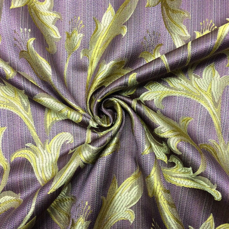 May include: Purple fabric with a gold floral pattern. The fabric is woven with a subtle striped texture.